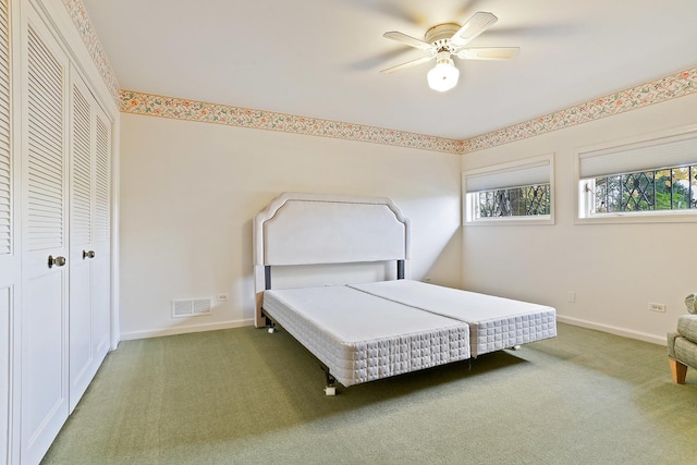 bedroom featuring ceiling fan and dark colored carpet