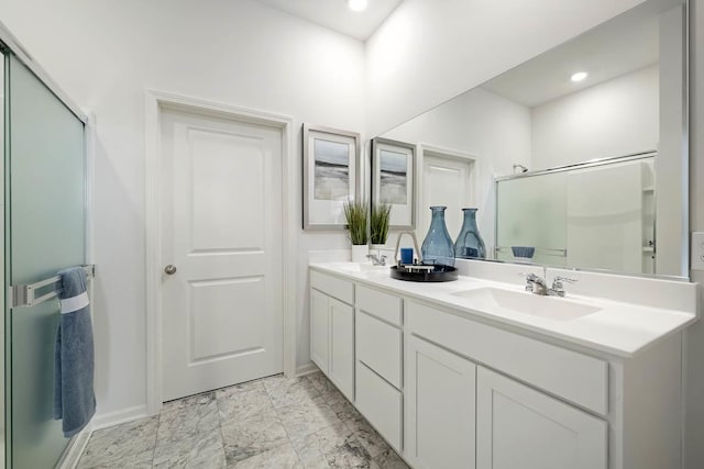 bathroom featuring vanity and a shower with door