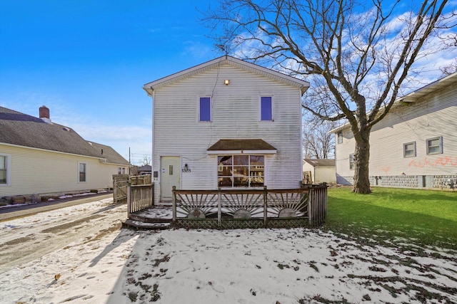 snow covered property with a yard