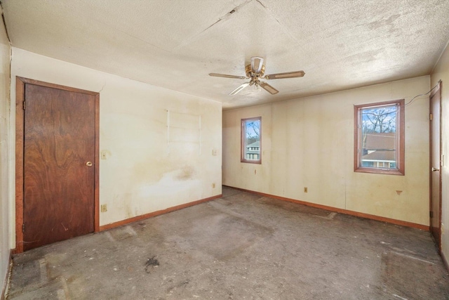 spare room with ceiling fan and a textured ceiling