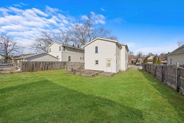 back of house with a lawn