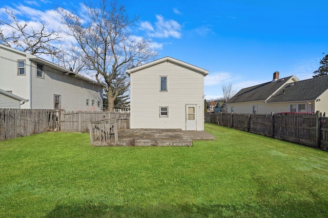 rear view of property featuring a lawn and a patio area