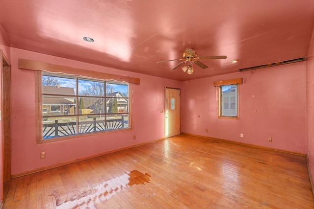 empty room with light hardwood / wood-style floors and ceiling fan