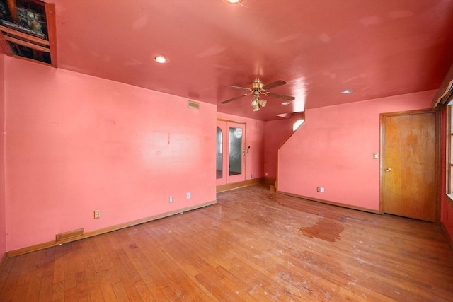 empty room with ceiling fan and light hardwood / wood-style floors