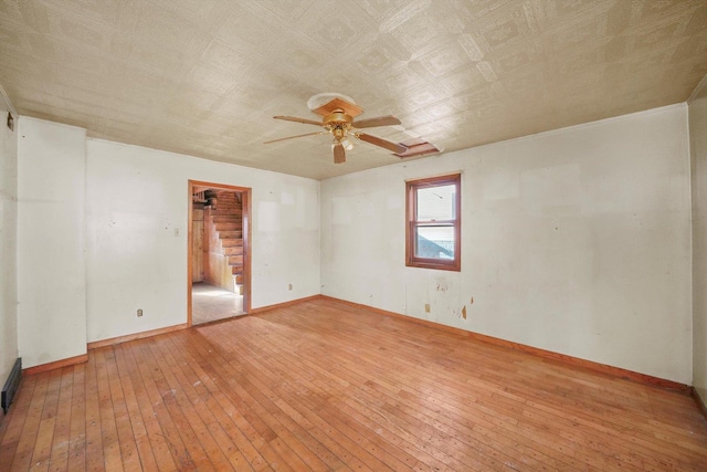 unfurnished room featuring light hardwood / wood-style flooring and ceiling fan