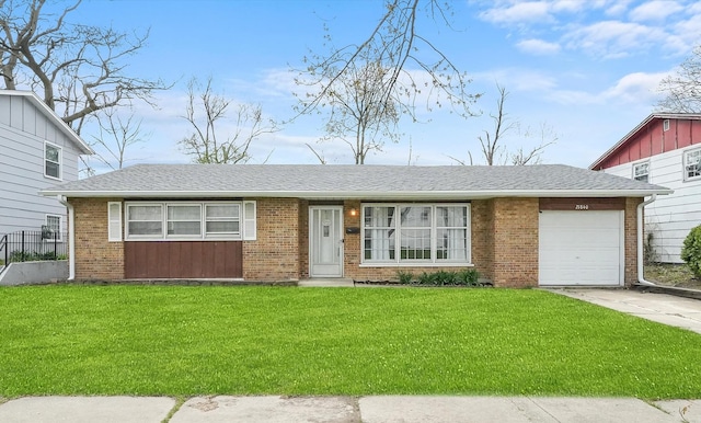 view of front of house featuring concrete driveway, brick siding, a front lawn, and an attached garage