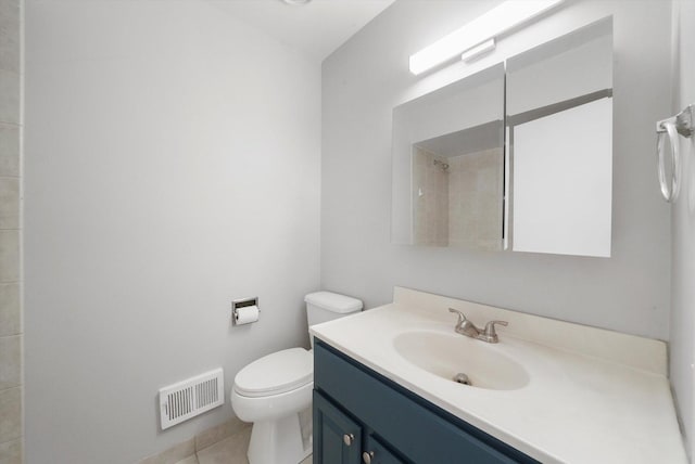 bathroom featuring vanity, tile patterned floors, toilet, tiled shower, and visible vents