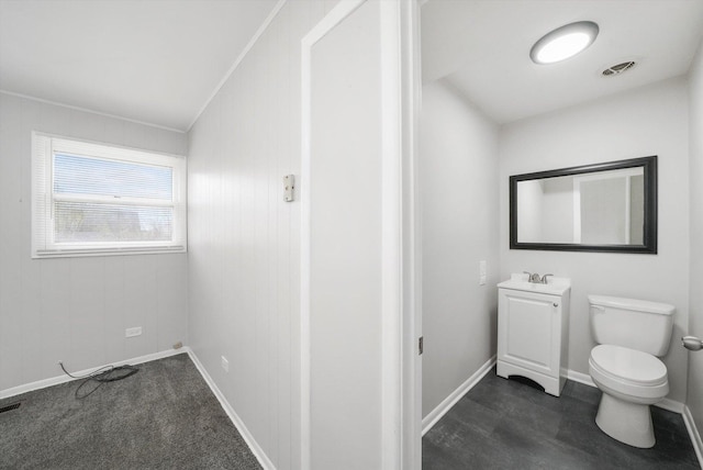 bathroom with vanity, baseboards, crown molding, toilet, and visible vents
