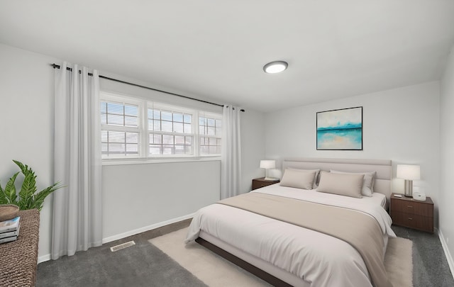 carpeted bedroom featuring visible vents and baseboards