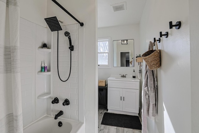 bathroom with vanity, hardwood / wood-style floors, and shower / bath combo with shower curtain