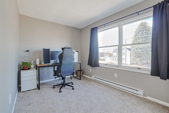 carpeted office space featuring a baseboard radiator, a textured ceiling, and a wealth of natural light