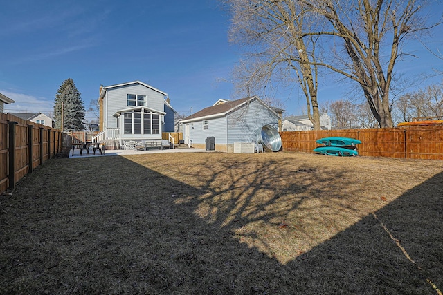 back of property featuring a lawn and a patio area