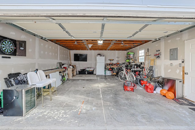 garage with a garage door opener, electric panel, and white fridge