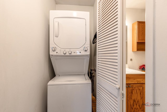 laundry room featuring stacked washer and dryer