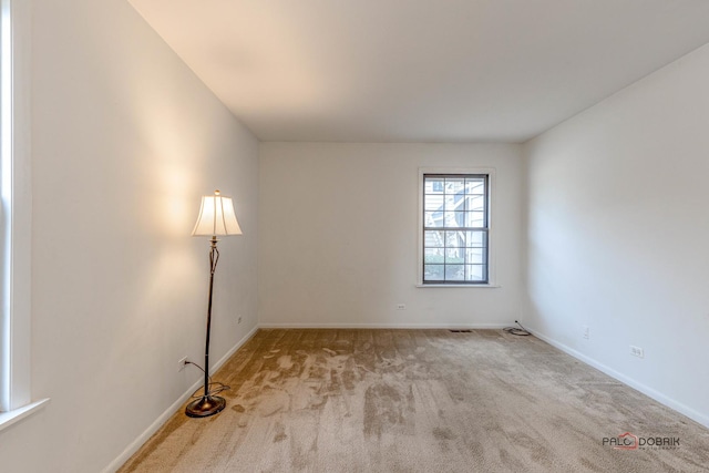 unfurnished room with light colored carpet