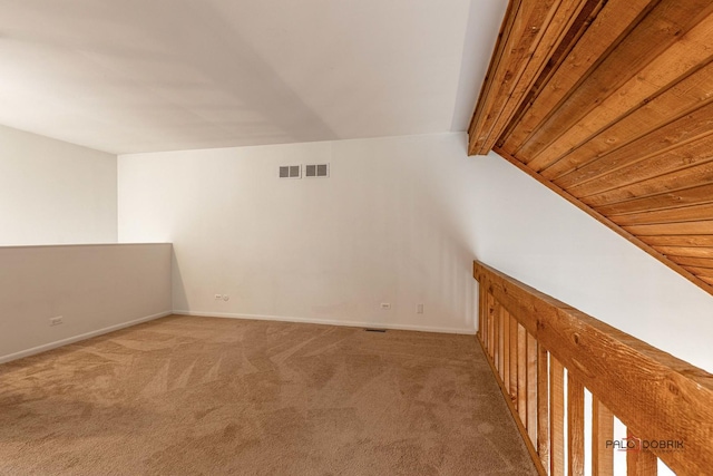 bonus room with vaulted ceiling with beams and carpet