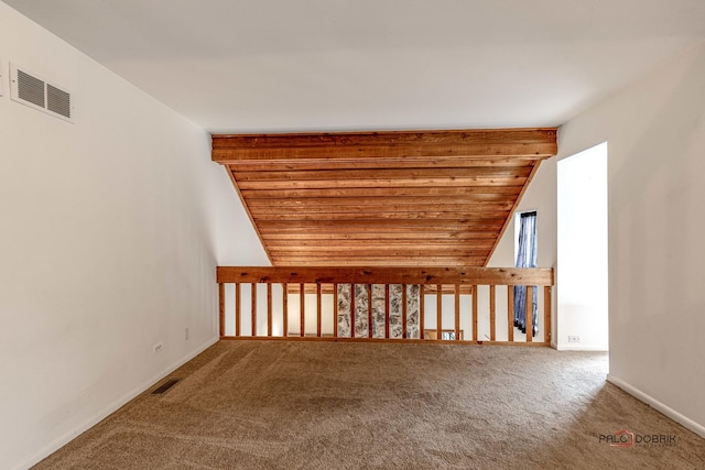 bonus room featuring carpet floors and vaulted ceiling