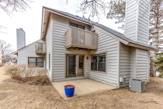 back of house featuring a balcony, cooling unit, and a patio area