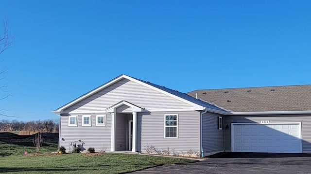 ranch-style home featuring a garage and a front yard