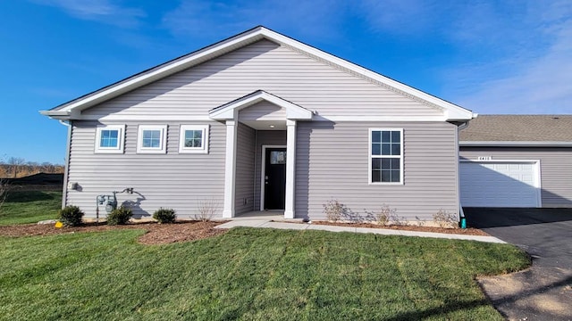 view of front facade with a garage and a front yard