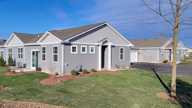 ranch-style house featuring a front yard and central air condition unit