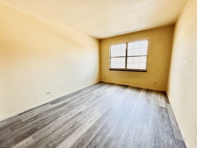 spare room with hardwood / wood-style floors