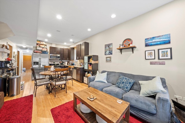 living area with light wood-style floors and recessed lighting