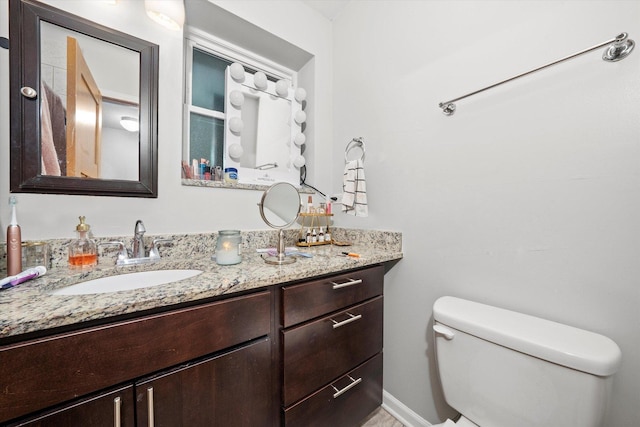 bathroom with toilet and vanity