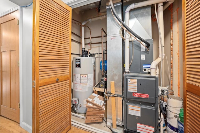 utility room featuring water heater and heating unit