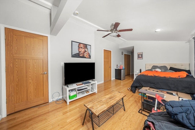 bedroom featuring ceiling fan, vaulted ceiling, baseboards, and wood finished floors