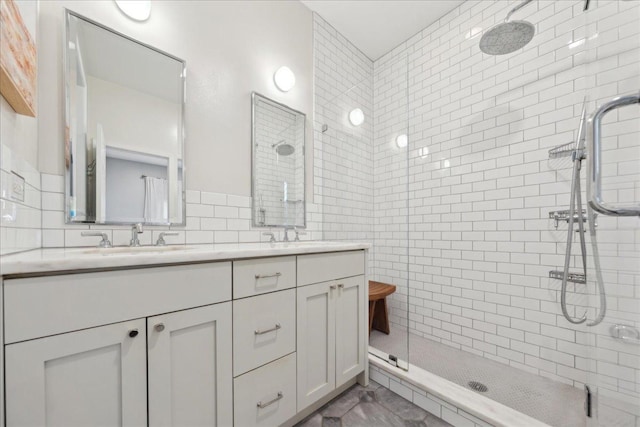 bathroom with backsplash, vanity, tile walls, and a tile shower