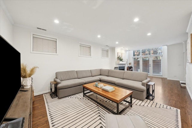 living room with ornamental molding and wood-type flooring