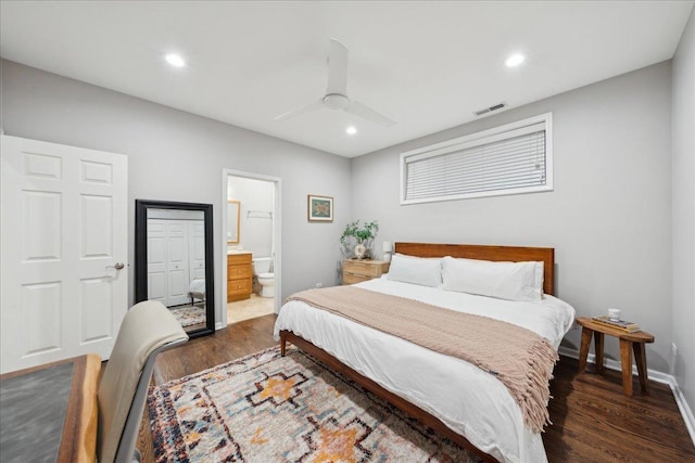 bedroom featuring dark wood-type flooring, ceiling fan, and connected bathroom