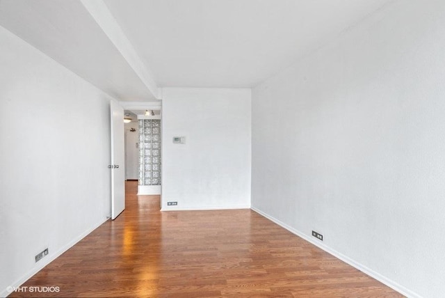 spare room with wood-type flooring