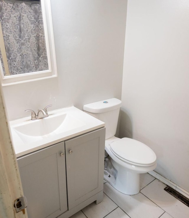 bathroom with vanity, tile patterned floors, and toilet