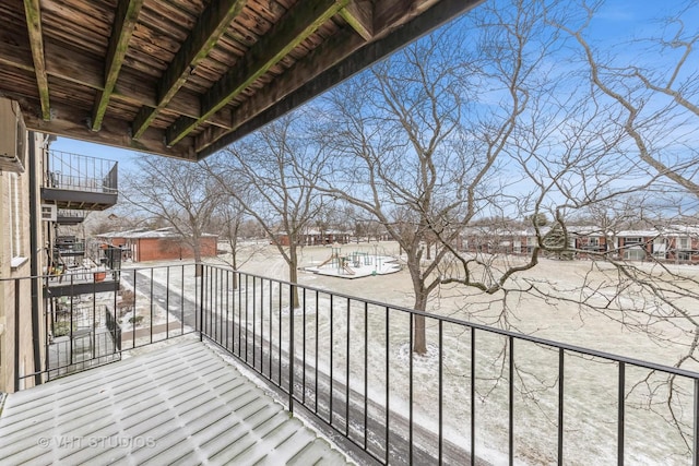 view of snow covered back of property