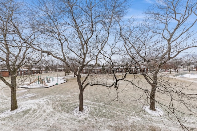 yard covered in snow with playground community