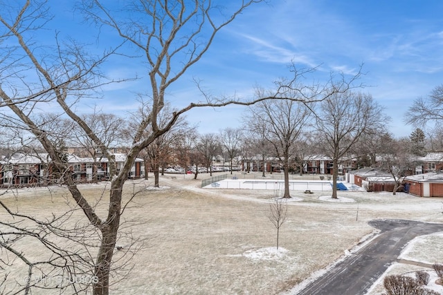 snowy yard featuring a residential view