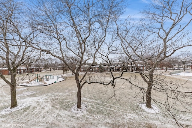 snowy yard featuring playground community