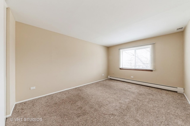 spare room with carpet floors, baseboards, visible vents, and baseboard heating