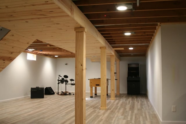 basement with wood ceiling and hardwood / wood-style flooring