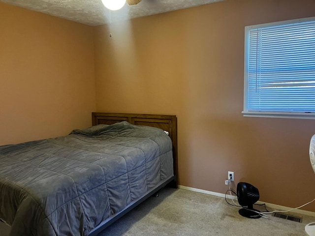 carpeted bedroom featuring a textured ceiling