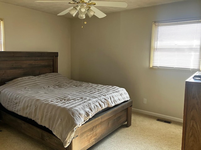 bedroom with light colored carpet and ceiling fan