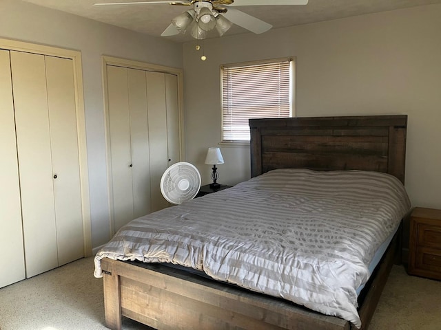 bedroom with two closets and ceiling fan