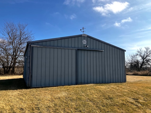 view of outbuilding featuring a lawn