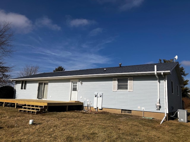 rear view of house with a yard and a deck