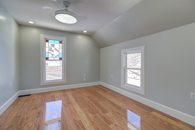 bonus room with lofted ceiling and light hardwood / wood-style floors