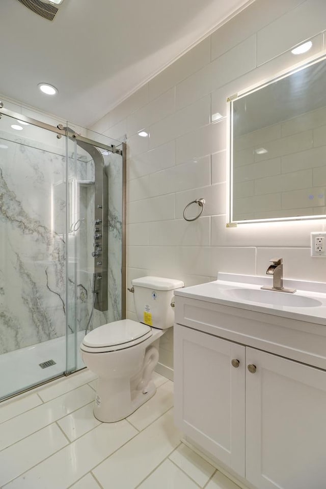 bathroom with toilet, a shower with shower door, tile walls, vanity, and backsplash