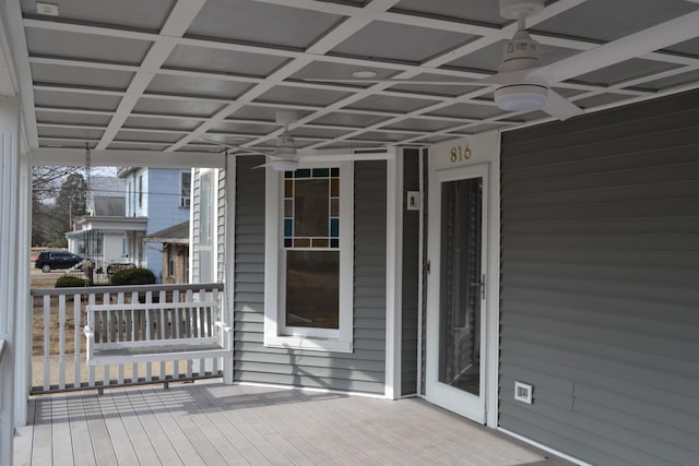 wooden deck featuring ceiling fan