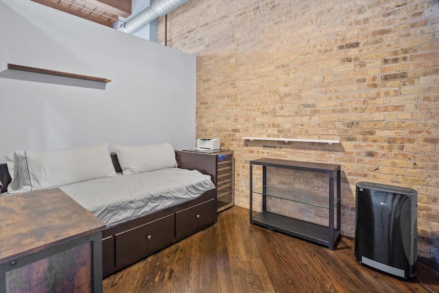 bedroom with a high ceiling, dark hardwood / wood-style floors, and a fireplace